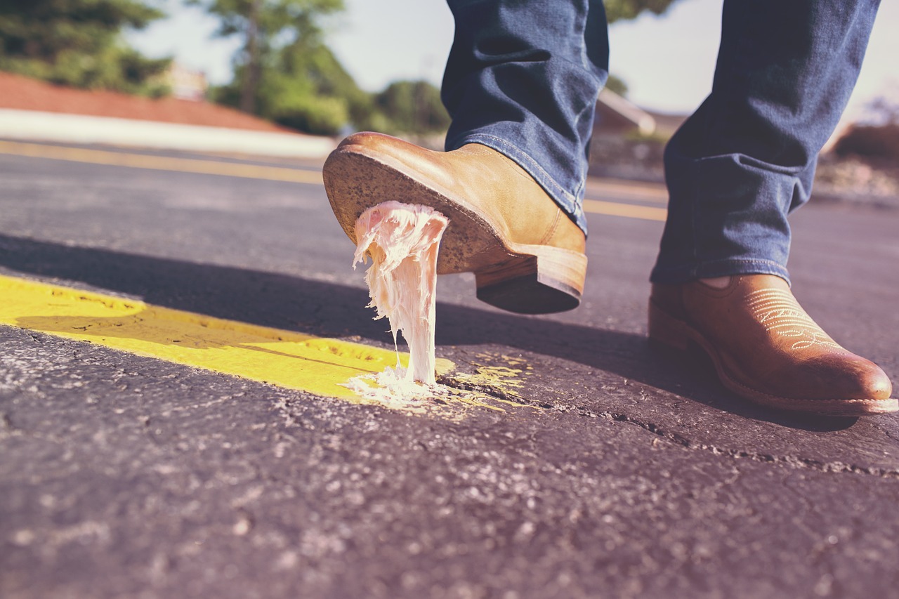 bubble gum on sidewalk sticking to the sole of a boot