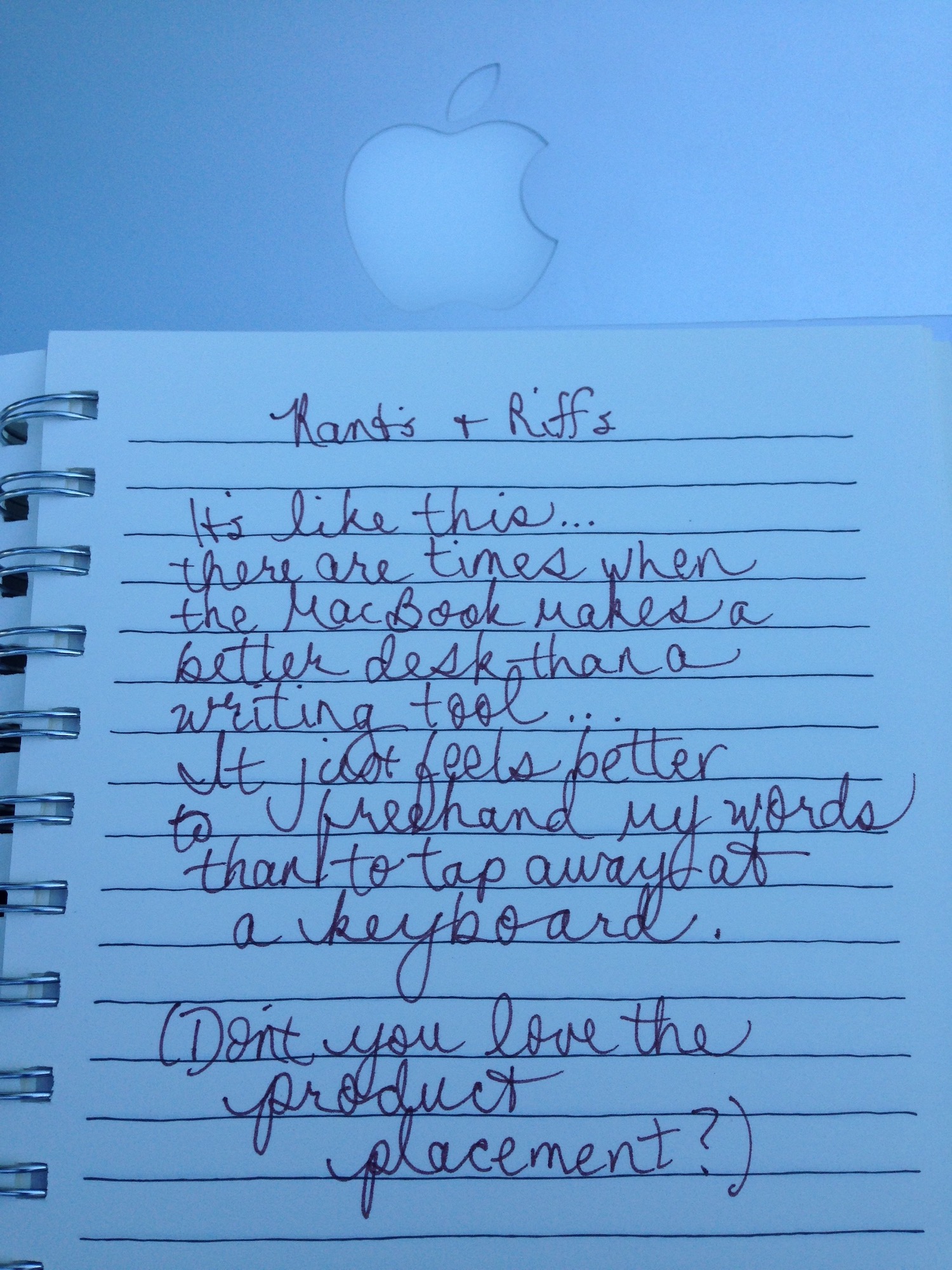 notebook page of writing sitting on top of a MacBook