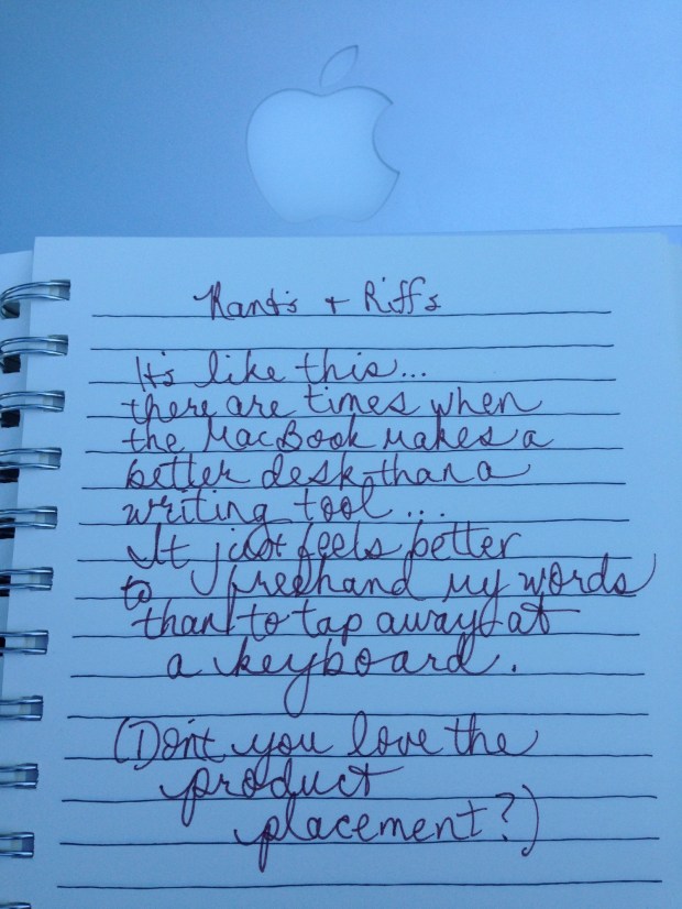 notebook page of writing sitting on top of a MacBook