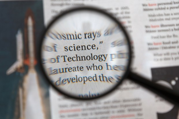 magnifying glass held over printed text