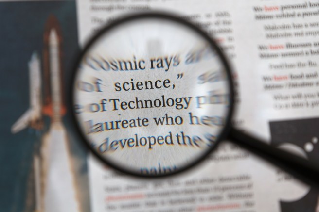 magnifying glass held over printed text